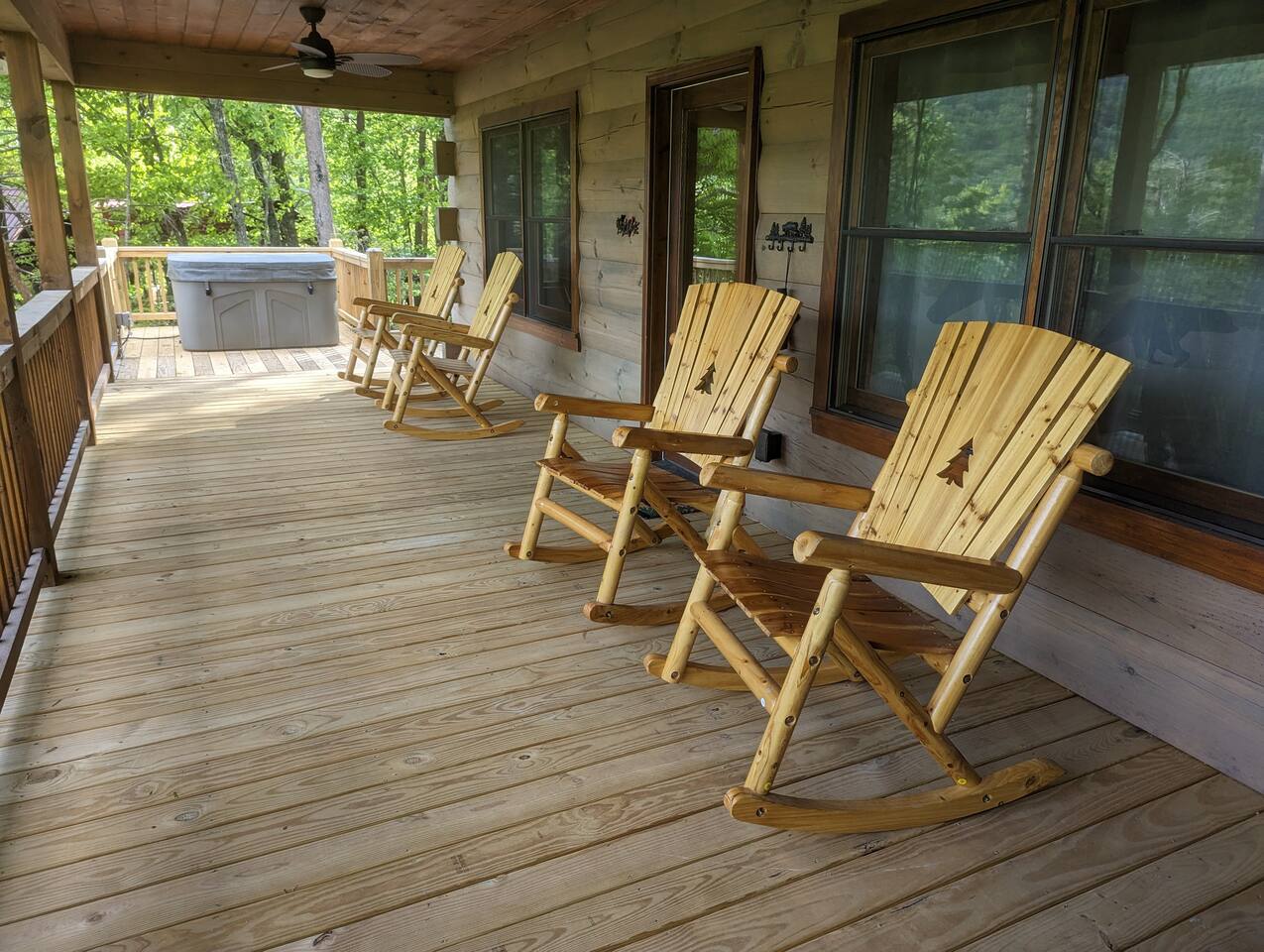 Peaceful mountain cabin deck with rocking chairs overlooking the trees in Cherry Log, Georgia